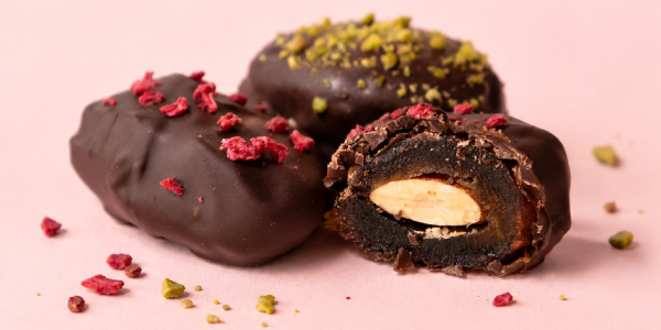 Mejdool-dipped treats with a pink background