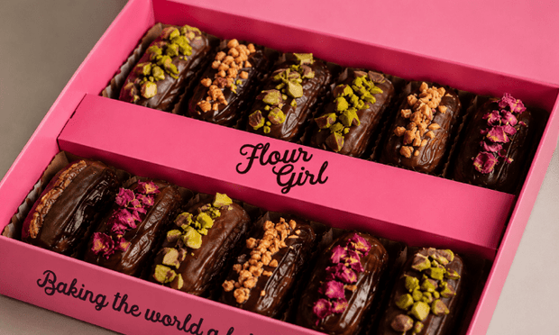 Pink box of assorted filled premium mejdool treats with 'Flour Girl' branding.