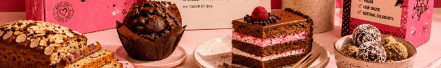 Flour Girl dessert packaging with various baked goods on a pink background