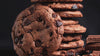 Vegan chocolate chip cookies stacked with chocolate pieces by Flour Girl Bakeries